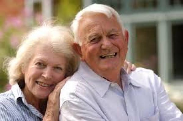 elderly wife hugs husband