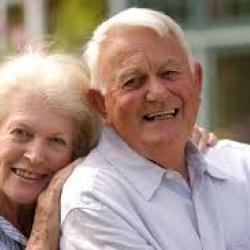 elderly wife hugs husband